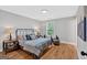 Cozy bedroom featuring wood floors, neutral walls, a comfortable queen bed and seating area at 786 Neal Nw St, Atlanta, GA 30318