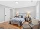 Comfortable bedroom with wood floors, neutral walls, queen bed, an armchair and ottoman at 786 Neal Nw St, Atlanta, GA 30318