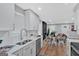 Bright open kitchen featuring white cabinets, stainless steel appliances, and an adjacent dining area at 786 Neal Nw St, Atlanta, GA 30318