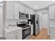 Modern kitchen featuring stainless steel appliances, white cabinetry, and wood flooring at 786 Neal Nw St, Atlanta, GA 30318