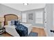 Cozy bedroom with a bed with stylish pillows, natural light, and wood floors at 786 Neal Nw St, Atlanta, GA 30318