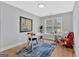 Well-lit home office featuring a desk, comfortable seating, wood floors, and a large window at 786 Neal Nw St, Atlanta, GA 30318
