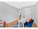 Home office space with a desk, blue chair, wood floors, and a large window at 786 Neal Nw St, Atlanta, GA 30318