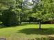 Green backyard featuring mature trees, lawn and various trees creating shade at 856 New Hope Rd, Fayetteville, GA 30214