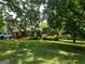 Charming red brick home with a lush front yard and mature shade trees at 856 New Hope Rd, Fayetteville, GA 30214