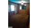 Traditional living room featuring wood paneling, neutral carpeting, and natural light from the window at 856 New Hope Rd, Fayetteville, GA 30214