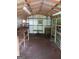 Shed interior featuring workbenches and shelving, illuminated by fluorescent lights at 856 New Hope Rd, Fayetteville, GA 30214
