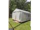 Exterior view of a metal storage shed on a grassy lawn with mature trees in the background at 856 New Hope Rd, Fayetteville, GA 30214