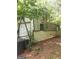 Exterior view of a weathered, metal storage shed surrounded by trees and vegetation at 856 New Hope Rd, Fayetteville, GA 30214