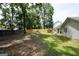 Fenced backyard featuring a well-maintained lawn and mature shade trees at 9067 Bob Jackson Dr, Jonesboro, GA 30238