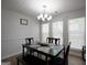 Traditional dining room with modern chandelier, table, bench, and multiple windows at 9067 Bob Jackson Dr, Jonesboro, GA 30238