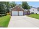 Charming single-story brick home with a two-car garage and a long driveway at 9067 Bob Jackson Dr, Jonesboro, GA 30238