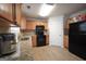Bright kitchen with wood cabinets, granite countertops, and black appliances at 9067 Bob Jackson Dr, Jonesboro, GA 30238