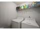 Laundry room with white washer, white dryer, and shelving at 9067 Bob Jackson Dr, Jonesboro, GA 30238