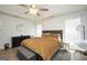 Bright main bedroom with tray ceiling, fan, and natural light at 9067 Bob Jackson Dr, Jonesboro, GA 30238