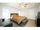 Spacious main bedroom with tray ceiling, ceiling fan and windows at 9067 Bob Jackson Dr, Jonesboro, GA 30238