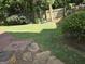 Landscaped backyard featuring a stone pathway and mature trees at 3773 Summer Rose Dr, Atlanta, GA 30341