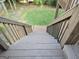 Wooden stairs leading to a backyard with mature trees and a brick landing at 3773 Summer Rose Dr, Atlanta, GA 30341