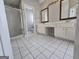 Bright bathroom featuring a shower, double vanity, and classic tile flooring for a timeless appeal at 3773 Summer Rose Dr, Atlanta, GA 30341