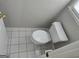 Bathroom toilet with neutral tile flooring; door ajar at 3773 Summer Rose Dr, Atlanta, GA 30341