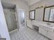 Bright bathroom featuring a shower, double vanity, and classic tile flooring for a timeless appeal at 3773 Summer Rose Dr, Atlanta, GA 30341