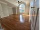 Large bedroom with hardwood floors, a ceiling fan, and a big arched window with lots of natural light at 3773 Summer Rose Dr, Atlanta, GA 30341