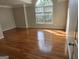 Spacious bedroom featuring natural light from a large arched window and gleaming hardwood floors at 3773 Summer Rose Dr, Atlanta, GA 30341