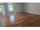 A bright bedroom with hardwood floors and window allowing natural light to brighten the space at 3773 Summer Rose Dr, Atlanta, GA 30341
