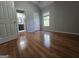Bedroom features gleaming hardwood floors and an adjoining bathroom with vanity and large window at 3773 Summer Rose Dr, Atlanta, GA 30341