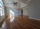 This is a spacious bedroom with hardwood floors, a ceiling fan, and large windows for natural light at 3773 Summer Rose Dr, Atlanta, GA 30341