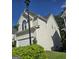 Two-story home with white siding, attached garage, arch window, and lush landscaping at 3773 Summer Rose Dr, Atlanta, GA 30341