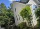 Side view of the house with white siding, garden trellis, and lush landscaping at 3773 Summer Rose Dr, Atlanta, GA 30341