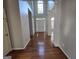 Open foyer with hardwood floors and natural light from a tall arched window at 3773 Summer Rose Dr, Atlanta, GA 30341