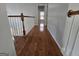 Hallway featuring beautiful hardwood floors and a staircase, creating a warm and inviting atmosphere at 3773 Summer Rose Dr, Atlanta, GA 30341