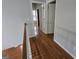 Upstairs hallway with pristine gray walls, gleaming hardwood floors and multiple entrances to bedrooms and bathrooms at 3773 Summer Rose Dr, Atlanta, GA 30341