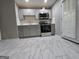 Contemporary kitchen featuring stainless appliances, gray cabinets, and elegant marble-style tile flooring at 3773 Summer Rose Dr, Atlanta, GA 30341