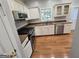 Kitchen boasts stainless steel appliances, granite counters, wood floors, and bright natural light at 3773 Summer Rose Dr, Atlanta, GA 30341