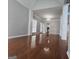 Bright living room with hardwood floors, chandelier, and tall ceilings with decorative columns at 3773 Summer Rose Dr, Atlanta, GA 30341