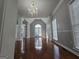 Bright, open-concept living room with hardwood floors and elegant chandelier at 3773 Summer Rose Dr, Atlanta, GA 30341