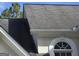 A close-up of the roof and arched window detailing of this home at 3773 Summer Rose Dr, Atlanta, GA 30341
