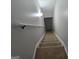 Carpeted staircase going down, offering a comfortable and safe transition between floors at 3773 Summer Rose Dr, Atlanta, GA 30341
