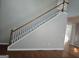 Carpeted staircase with natural wood railing provides access to upper level at 3773 Summer Rose Dr, Atlanta, GA 30341