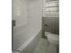 Bathroom with a tub-shower combination and modern fixtures at 1684 Lake Harbin Rd, Morrow, GA 30260