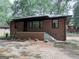 Charming brick home with a quaint front porch and freshly landscaped yard at 1684 Lake Harbin Rd, Morrow, GA 30260
