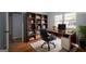Inviting home office with built-in bookshelf, hardwood floors, and natural light at 1684 Lake Harbin Rd, Morrow, GA 30260
