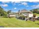 A covered patio offers an ideal outdoor space, complemented by a spacious backyard and mature trees at 465 Harris Dr, Conyers, GA 30012