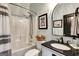 Stylish bathroom features a shower-tub combo, patterned shower curtain and a sleek vanity at 465 Harris Dr, Conyers, GA 30012