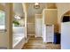 Bright bathroom featuring a soaking tub, linen closet, and neutral color palette at 465 Harris Dr, Conyers, GA 30012