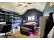 Cozy bedroom with vaulted ceilings, dark accent walls, and a modern ceiling fan at 465 Harris Dr, Conyers, GA 30012