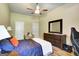 Comfortable bedroom with wood dresser, ceiling fan, and natural light at 465 Harris Dr, Conyers, GA 30012